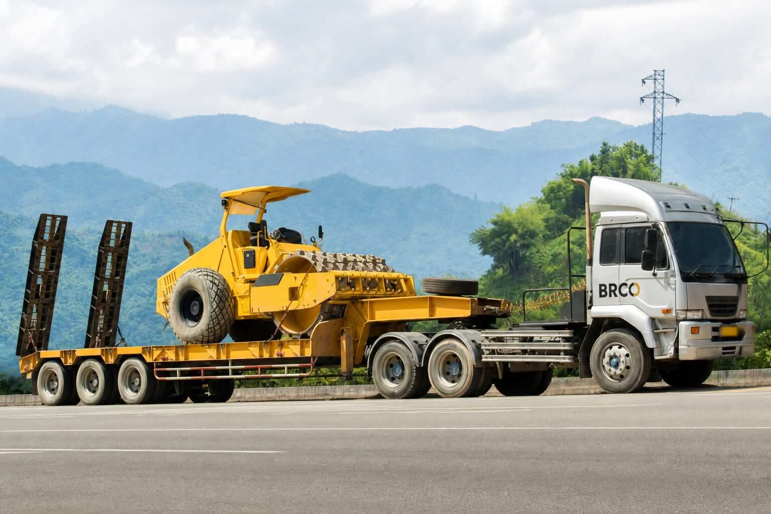 BRCO lowbed trailer hauling heavy equipment